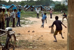What's cricket without an attentive audience? A crowd gathers to watch a game in a slum in CV Raman Nagar, Bangalore